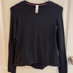 A simple black long-sleeved "Ivivva" shirt.